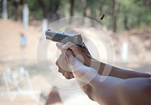 Man firing pistol at firing range photo