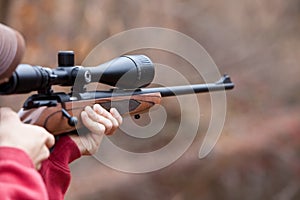 Man Firing a Rifle