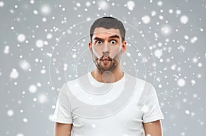 Man with fish-face over snow background