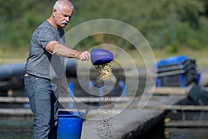 man fisherman feeding fishes