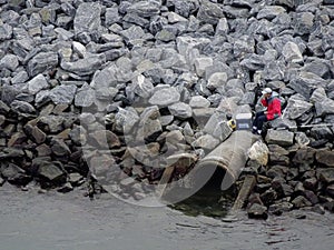 Man Fishes on Rocky Bank photo