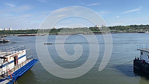 Man in a fishing boat cruising over Danube