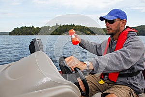 Man Fishing in Boat Marker Buoy and Sonar