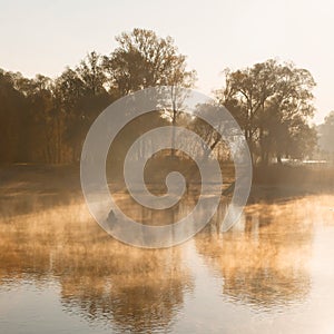 Man fishing on a boat in a mystic foggy lake