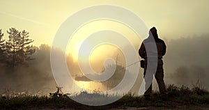 A man is fishing at dawn