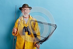 Man with fishing equipment going to rest on the banck of the river