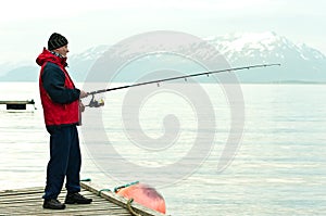 Man fishing in fiord photo