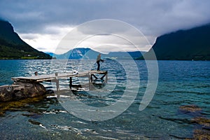 Man are fishing with fishing rods in Romsdal Fjord Romsdalsfjord. Andalsnes. Norway