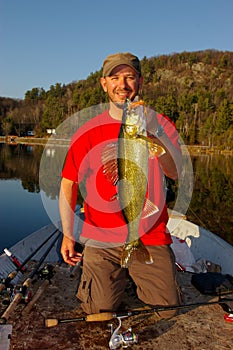 Man Fishing Holding Walleye