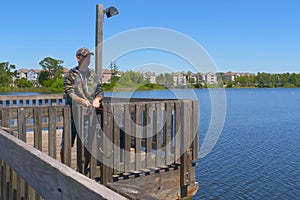 Man fishing and holds angling rod