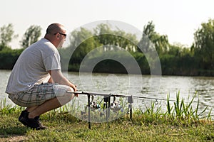 Man fishing at lake, Carp fishing