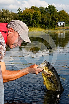 Man Fishing with Large Mouth Bass