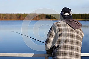 Man Fishing in the Midwest on Small Lake on Cold Day