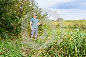 Man fishing on the river bank