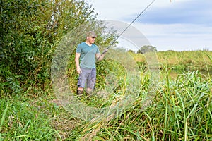 Man fishing on the river bank