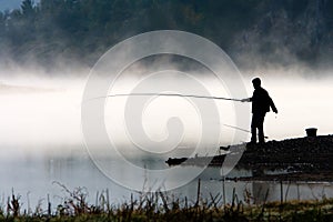 Man fishing at river shore