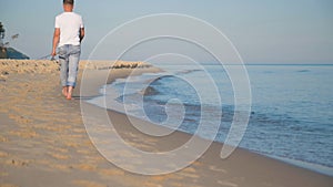 Man with fishing rod on beach