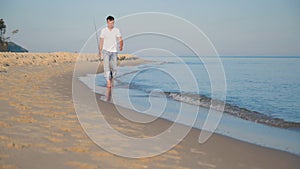 Man with fishing rod on beach