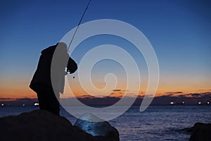 Man fishing on sunset