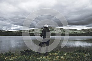 Man is fishing in the wilderness of the Arctic mountains