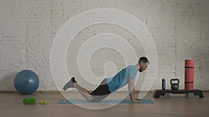 Man fitness coach in sportswear doing knee push ups exercise for online class at the home studio. HDR BT2020 HLG