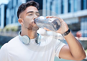 Man, fitness and drinking water in city after exercise, cardio workout or training outdoors. Thirsty male person