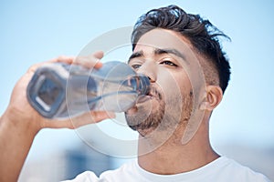 Man, fitness and drinking water in city for sustainability after running exercise, workout or training outdoors. Thirsty