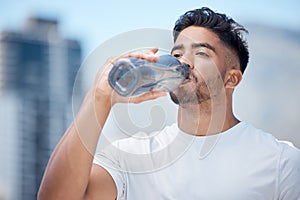 Man, fitness and drinking water in city workout, cardio exercise or running for sustainability outdoors. Thirsty male