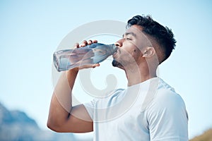 Man, fitness and drinking water in nature exercise, cardio workout or running for sustainability outdoors. Thirsty male