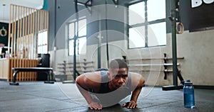 Man, fitness and push ups in workout, strength or exercise on floor for endurance at gym. Active male person