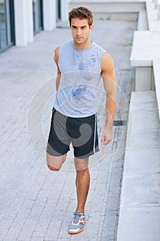 Man, fitness and stretching legs for workout, exercise or outdoor training and cardio preparation. Handsome or active