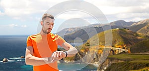 Man with fitness tracker training outdoors