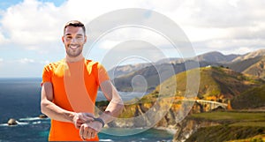 Man with fitness tracker training outdoors