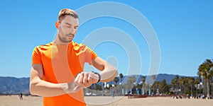 Man with fitness tracker training outdoors