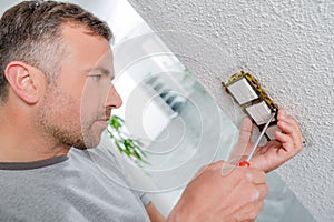 Man fitting light switches