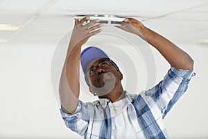 man fixes ceiling skirting photo