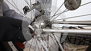 A man fixes the rear wheel on a mountain bike frame. Wrench. Bicycle repair. Close-up