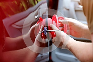 Man fixing car  dent by himself