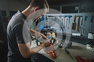 Man fixing a chainsaw in a service