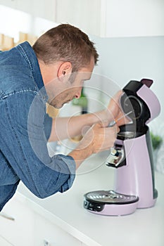 man fixing coffee machine photo