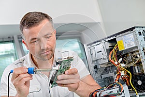 man fixing computer