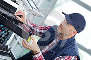 Man fixing copier in office