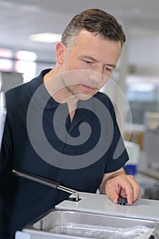 Man fixing a deep-fryer