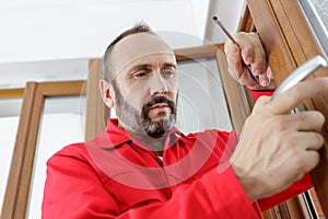 man fixing door handle with screwdriver