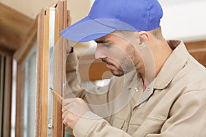 Man fixing door handle with screwdriver photo