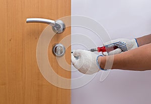 Man fixing the door with screwdriver