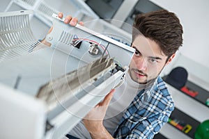 Man fixing electric radiator