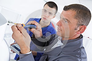 Man fixing electronic circuits in service center