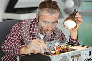 man fixing electronics
