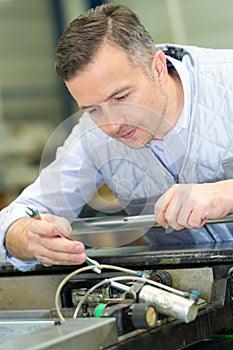 Man fixing electronics factory